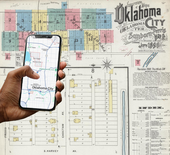An historic map of Oklahoma City, and a hand holding a cell phone with a screen showing a map of Oklahoma City